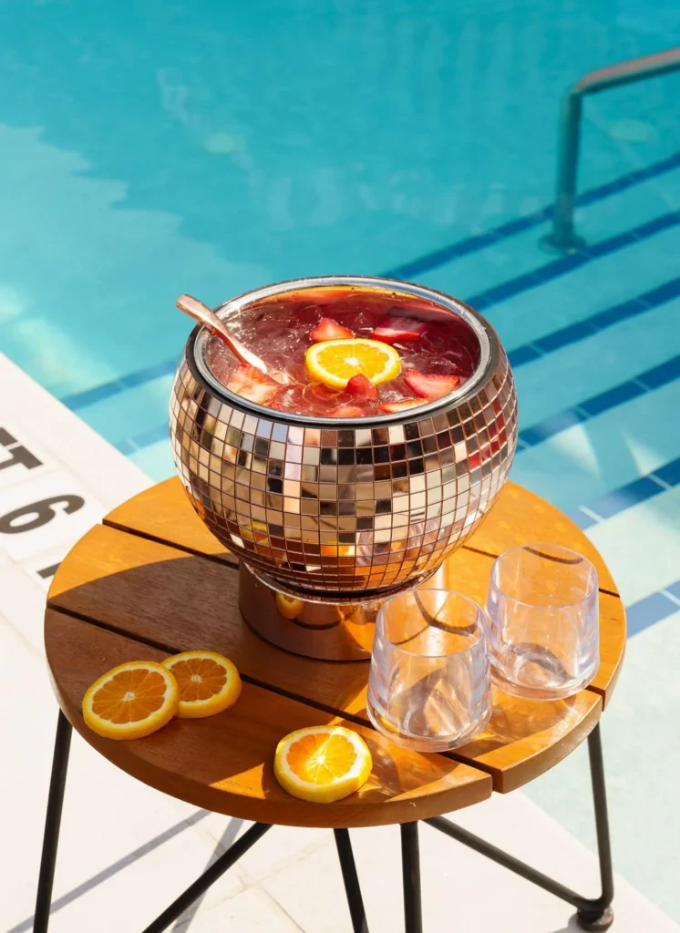 cocktail in disco ball container by the pool on the virgin rooftop in nashville