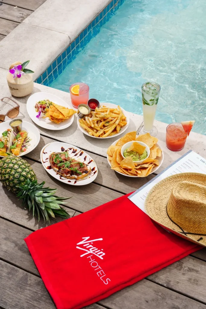 red menu with food items next to the pool on a rooftop in nashville