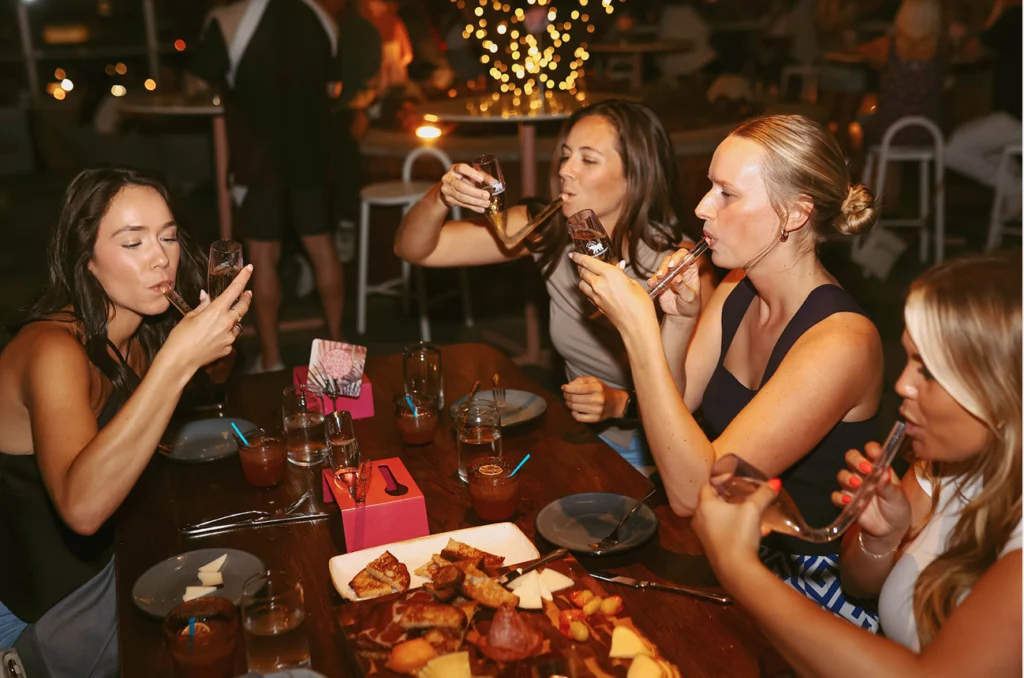 bachelorette group at la Jackson rooftop taking chambongs