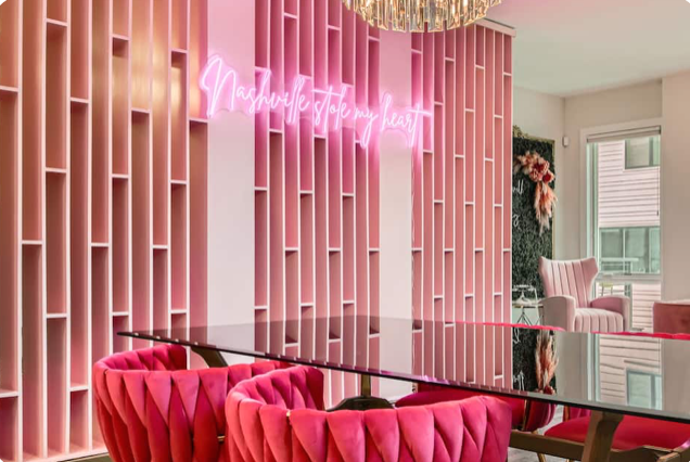 bachelorette airbnb in nashville in all pink, neon signs and disco balls