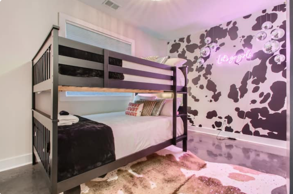 bachelorette airbnb in nashville in all pink, neon signs and disco balls
